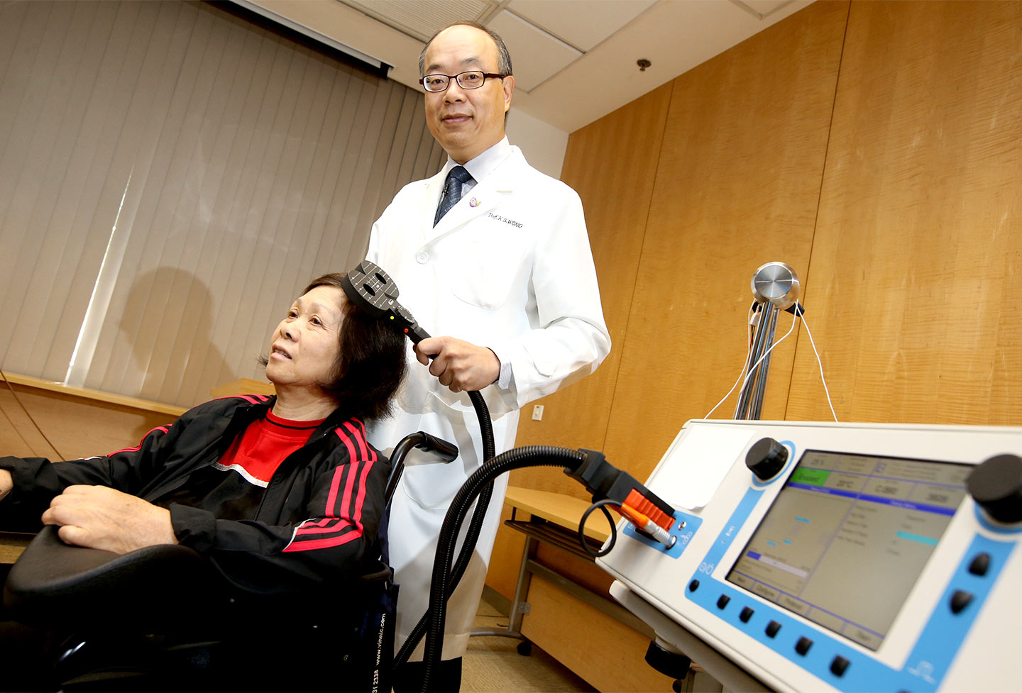 Prof. Lawrence Wong demonstrating iTBS treatments on a stroke patient