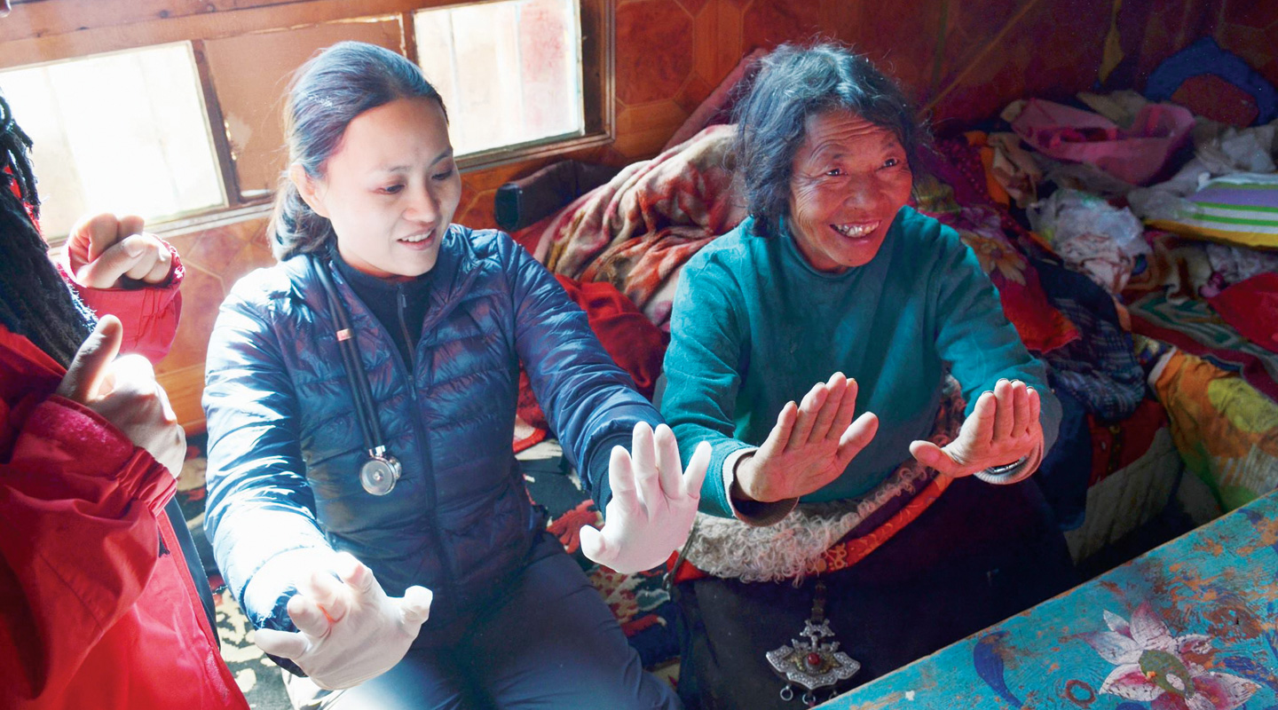 Conducting a basic examination of a Tibetan woman