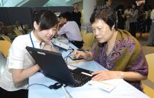 A staff demonstrating the 'Caring for Yourself – Managing your Diabetes' website.