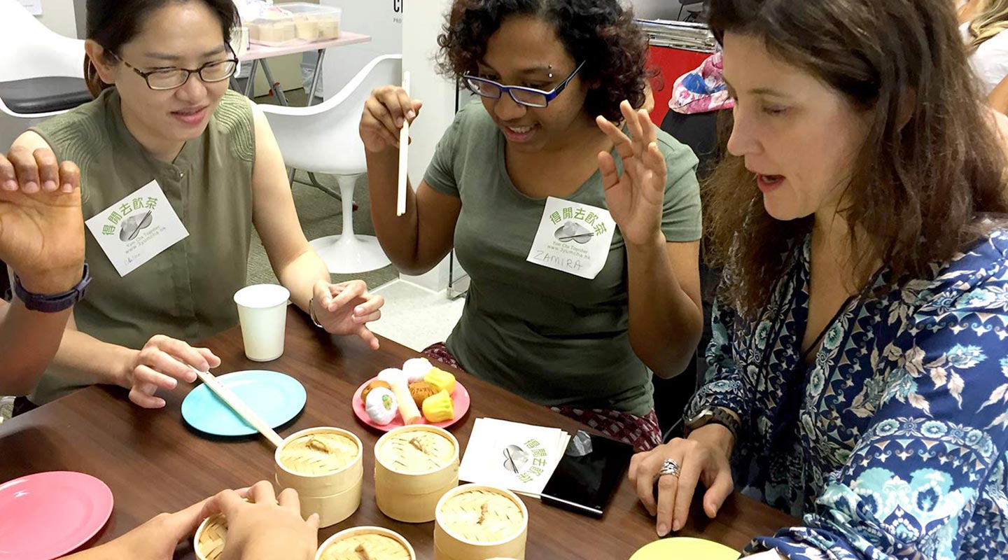 Shaw College’s international students practicing yum cha etiquettes with mock dim sum