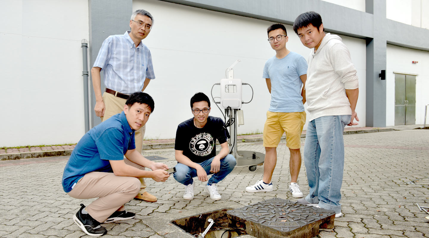 The device developed by the research team led by Prof. Wu Ke-li (2nd left), which is about 30x22x6 cm in size, can measure underground conditions of the drainage system