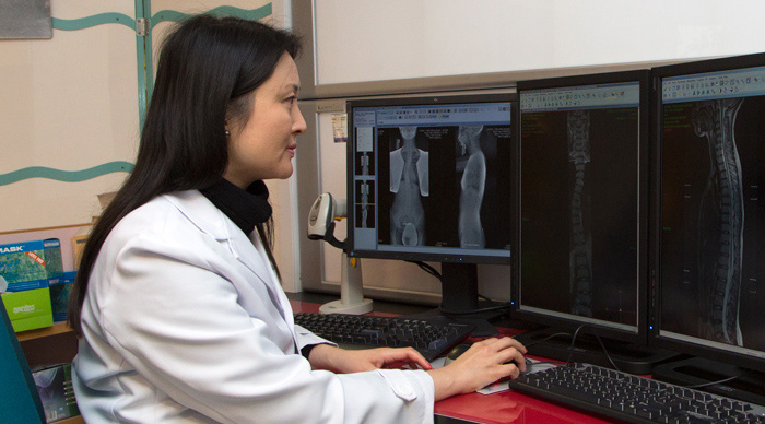 Professor Chu scrutinizes X-ray images