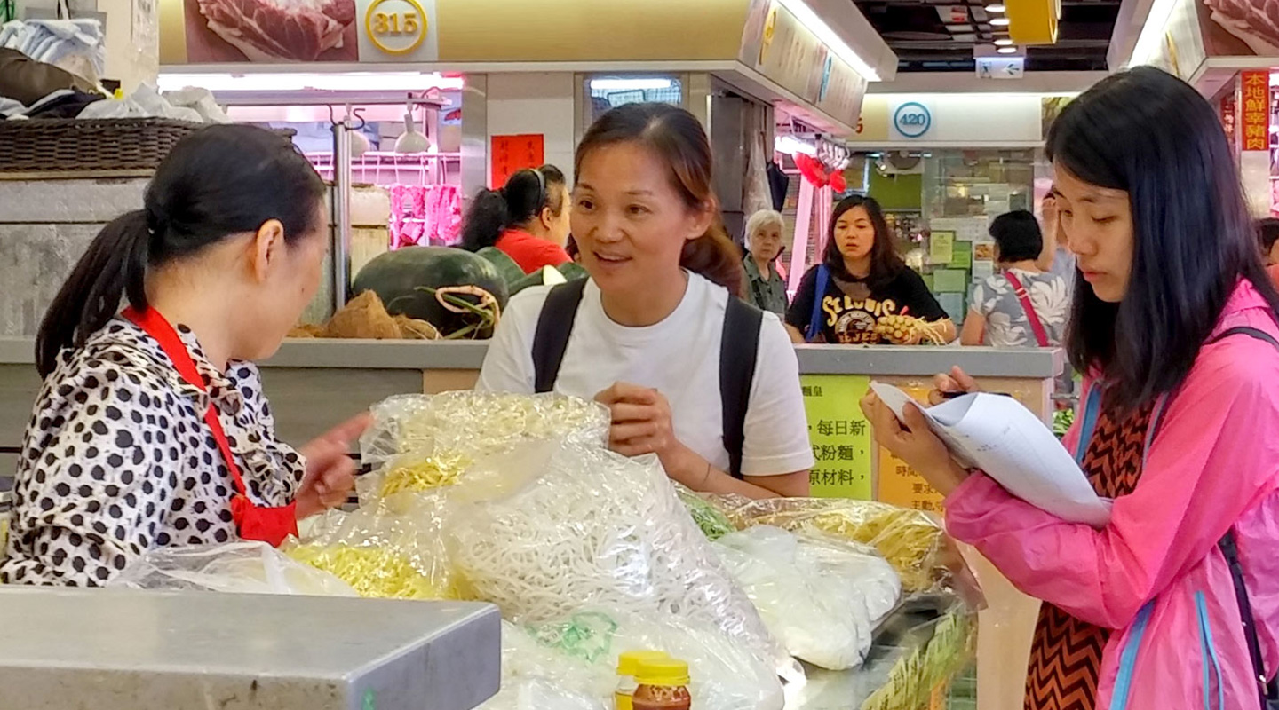 Students team up with a neighbourhood resident to interview tenants at Lok Fu Market